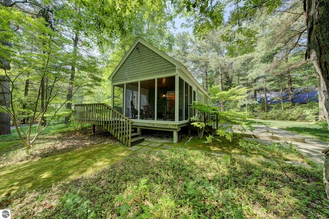 4079 E Oxford Dr, Leland, MI 49654 - back of property featuring a sunroom and a wooden deck