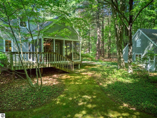 4079 E Oxford Dr, Leland, MI 49654 - view of yard with a sunroom and a wooden deck