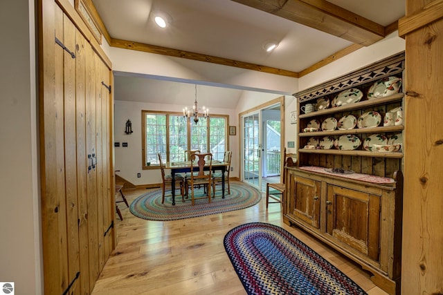 4079 E Oxford Dr, Leland, MI 49654 - dining area featuring a chandelier and light wood-style floors