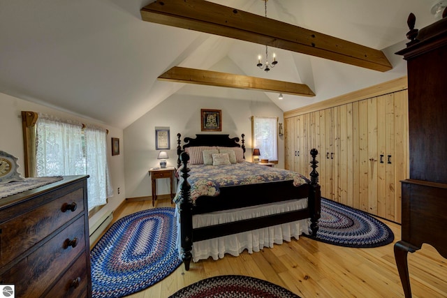 4079 E Oxford Dr, Leland, MI 49654 - bedroom with wood finished floors, multiple windows, and a chandelier