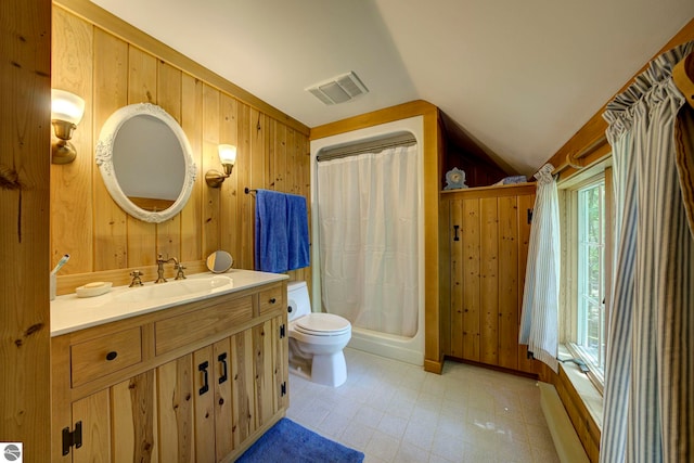 4079 E Oxford Dr, Leland, MI 49654 - bathroom featuring vanity, wooden walls, and vaulted ceiling