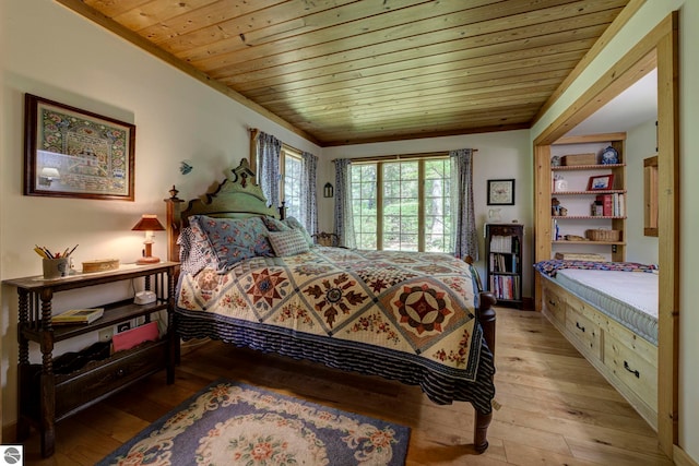 4079 E Oxford Dr, Leland, MI 49654 - bedroom featuring light wood finished floors and wooden ceiling