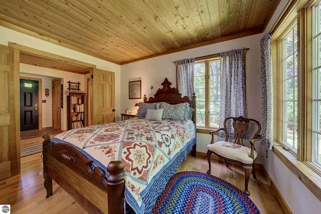4079 E Oxford Dr, Leland, MI 49654 - bedroom with light wood-style flooring, wooden ceiling, and ornamental molding