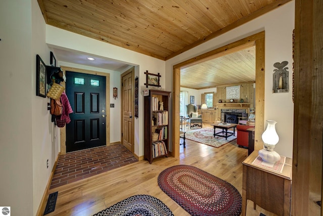 4079 E Oxford Dr, Leland, MI 49654 - entryway with wood-type flooring, a fireplace, and wood ceiling