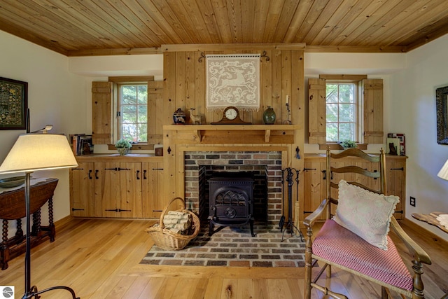 4079 E Oxford Dr, Leland, MI 49654 - living room with wooden ceiling, plenty of natural light, light wood-type flooring, a wood stove, and ornamental molding