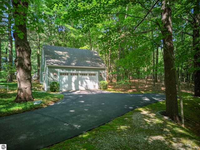 4079 E Oxford Dr, Leland, MI 49654 - view of front of home with a detached garage and roof with shingles
