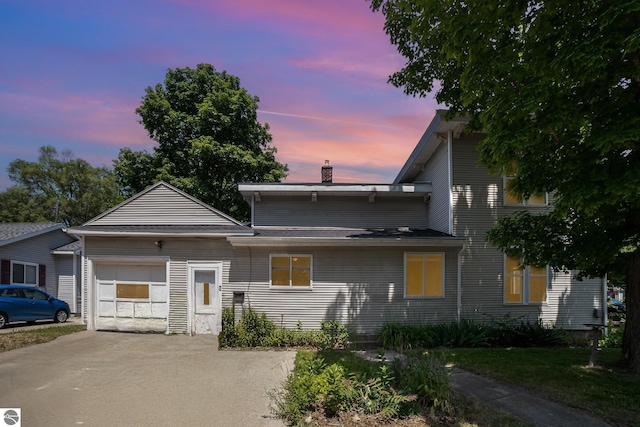 503 N Kinney Ave, Mount Pleasant, MI 48858 - view of front of home with driveway, a chimney, and an attached garage