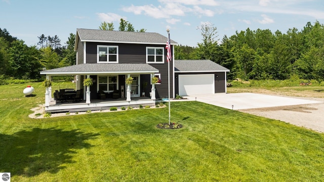 6330 Lund Rd SW, Fife Lake, MI 49633 - view of front of house with driveway, a porch, a front lawn, and a garage