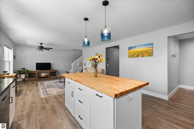 6330 Lund Rd SW, Fife Lake, MI 49633 - kitchen featuring wood counters, wood finished floors, a ceiling fan, and white cabinetry
