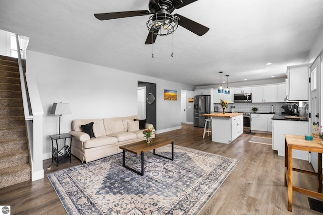 6330 Lund Rd SW, Fife Lake, MI 49633 - living area with a ceiling fan, stairway, wood finished floors, and recessed lighting