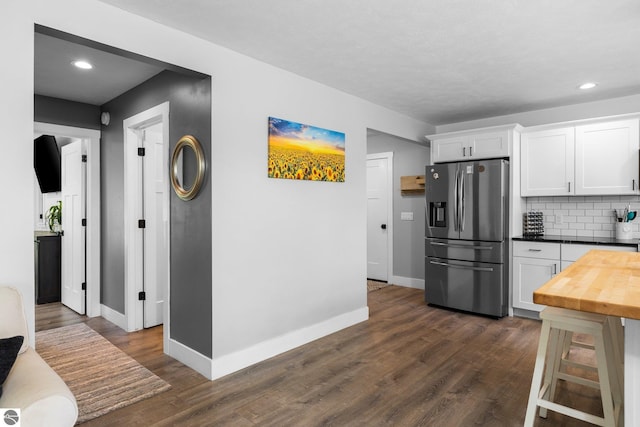 6330 Lund Rd SW, Fife Lake, MI 49633 - kitchen featuring stainless steel fridge, white cabinetry, dark wood-type flooring, backsplash, and recessed lighting
