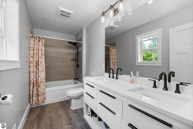 6330 Lund Rd SW, Fife Lake, MI 49633 - bathroom featuring double vanity, shower / tub combo, and wood finished floors