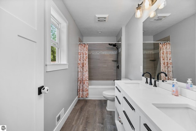 6330 Lund Rd SW, Fife Lake, MI 49633 - bathroom featuring double vanity, wood finished floors, and shower / tub combo with curtain