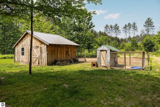 6330 Lund Rd SW, Fife Lake, MI 49633 - view of grassy yard featuring an outdoor structure and exterior structure