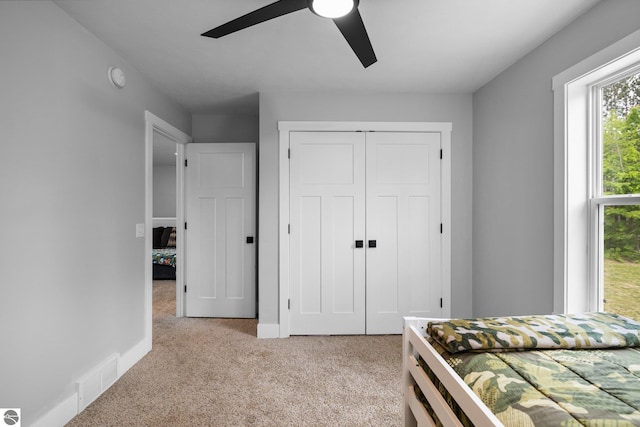 6330 Lund Rd SW, Fife Lake, MI 49633 - bedroom featuring light colored carpet, a closet, and ceiling fan