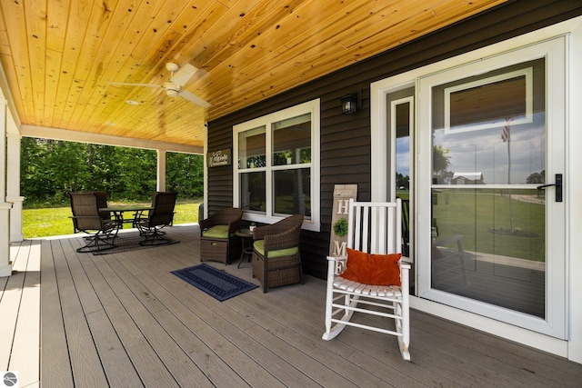 6330 Lund Rd SW, Fife Lake, MI 49633 - wooden porch with ceiling fan and outdoor dining area