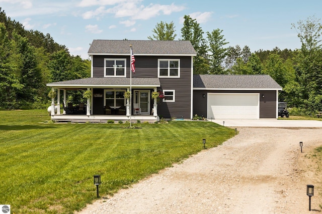 6330 Lund Rd SW, Fife Lake, MI 49633 - view of front of property featuring driveway, covered porch, an attached garage, and a front lawn