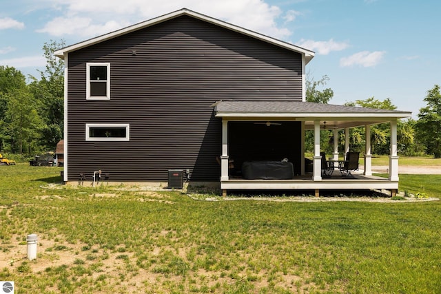 6330 Lund Rd SW, Fife Lake, MI 49633 - back of property with a yard and a wooden deck