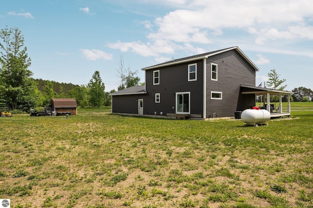 6330 Lund Rd SW, Fife Lake, MI 49633 - back of house with a lawn