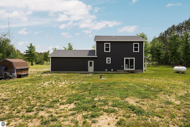 6330 Lund Rd SW, Fife Lake, MI 49633 - rear view of property with a lawn and a storage shed