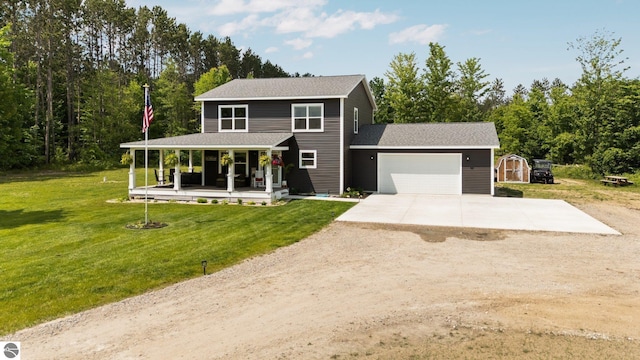6330 Lund Rd SW, Fife Lake, MI 49633 - view of front of property with covered porch, driveway, a front lawn, a garage, and a storage unit