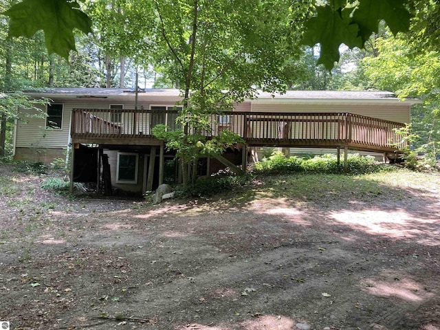 653 S Morrison Rd, West Branch, MI 48661 - rear view of property featuring a deck and dirt driveway