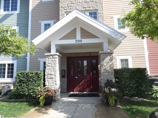 1246 Sunnyside Dr Unit 203, 4 & 8, Cadillac, MI 49601 - doorway to property featuring stone siding