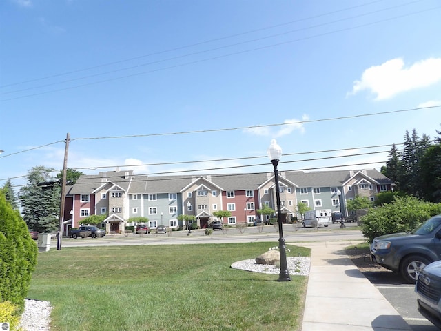 1246 Sunnyside Dr Unit 203, 4 & 8, Cadillac, MI 49601 - surrounding community featuring a residential view and a yard