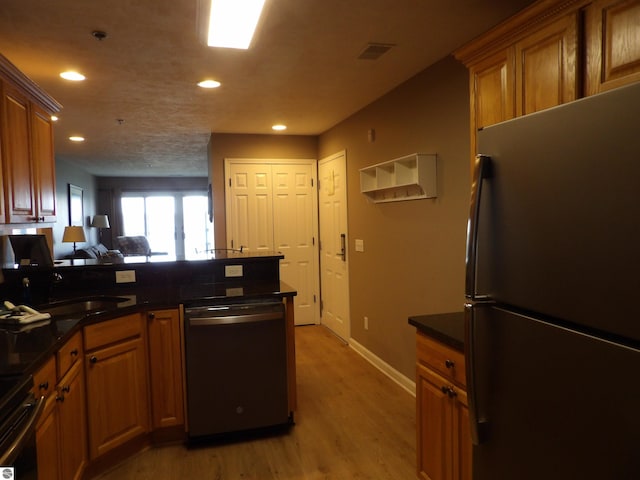 1246 Sunnyside Dr Unit 203, 4 & 8, Cadillac, MI 49601 - kitchen with freestanding refrigerator, dishwasher, recessed lighting, light wood-style floors, and a peninsula