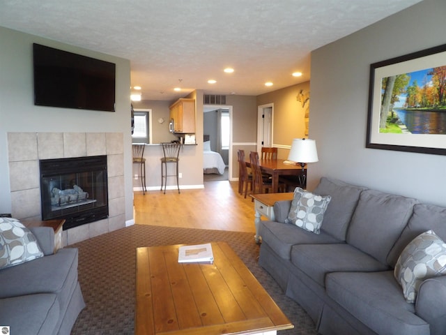 1246 Sunnyside Dr Unit 203, 4 & 8, Cadillac, MI 49601 - carpeted living area with recessed lighting, a fireplace, and a textured ceiling