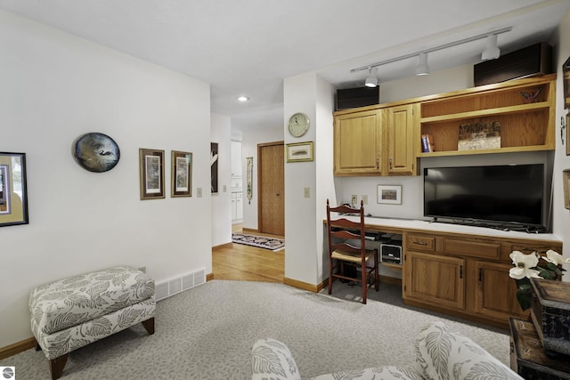 3810 Ridgeway Pl, Traverse City, MI 49684 - living room with built in desk, light carpet, recessed lighting, and track lighting