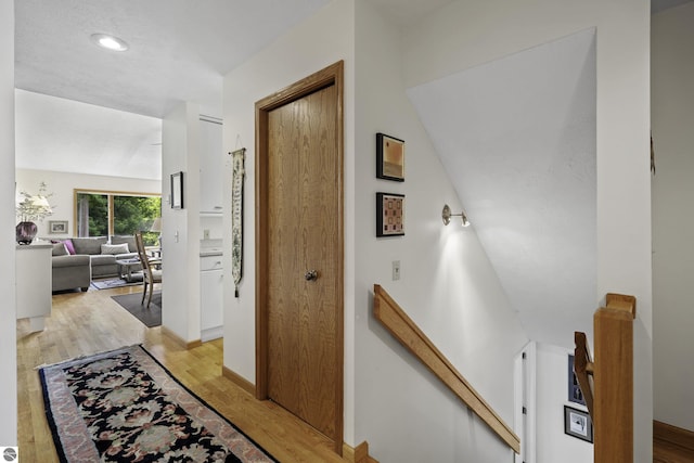 3810 Ridgeway Pl, Traverse City, MI 49684 - hall featuring an upstairs landing and light wood-style flooring