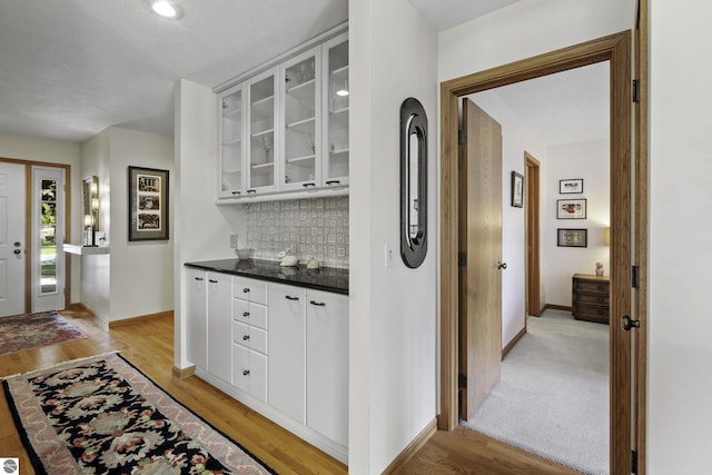 3810 Ridgeway Pl, Traverse City, MI 49684 - bar with tasteful backsplash and light wood finished floors
