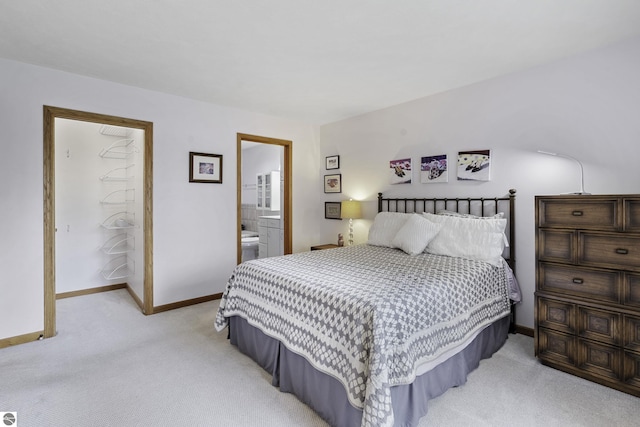 3810 Ridgeway Pl, Traverse City, MI 49684 - bedroom with light colored carpet and ensuite bathroom
