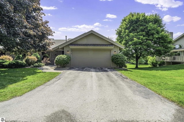 3810 Ridgeway Pl, Traverse City, MI 49684 - view of front of property with asphalt driveway, an attached garage, a front lawn, and brick siding