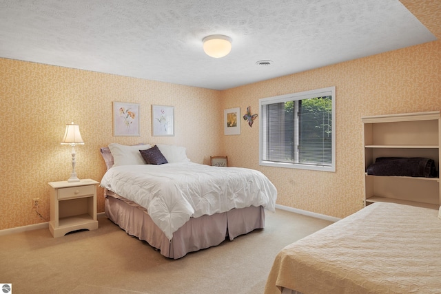 3810 Ridgeway Pl, Traverse City, MI 49684 - bedroom featuring wallpapered walls, carpet, and a textured ceiling