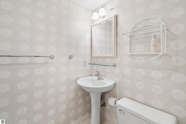 3810 Ridgeway Pl, Traverse City, MI 49684 - bathroom with wallpapered walls and toilet