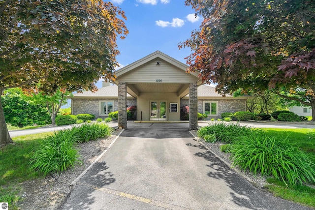 3810 Ridgeway Pl, Traverse City, MI 49684 - view of front of property with french doors and asphalt driveway
