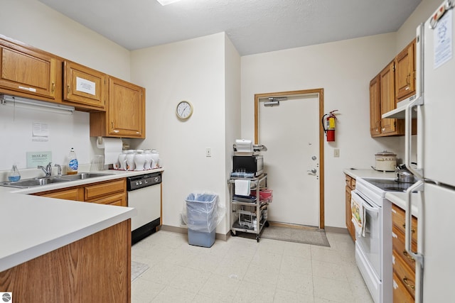 3810 Ridgeway Pl, Traverse City, MI 49684 - kitchen with white appliances, light countertops, under cabinet range hood, and light flooring