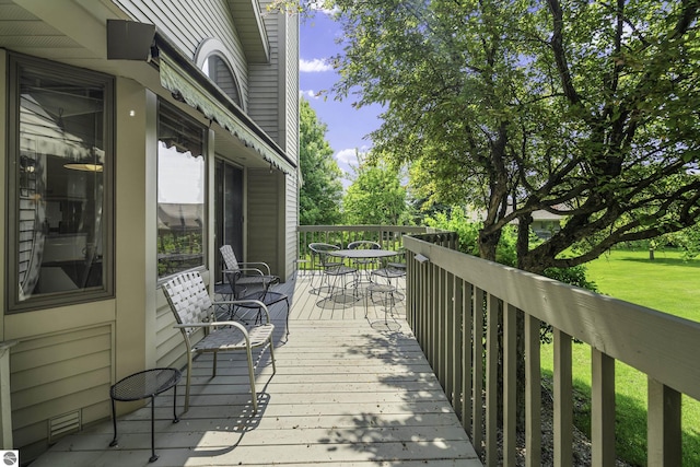 3810 Ridgeway Pl, Traverse City, MI 49684 - wooden terrace featuring outdoor dining area and a lawn
