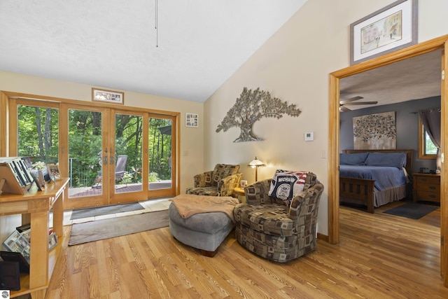 3048 Frankfort Hwy, Frankfort, MI 49635 - sitting room featuring french doors, wood finished floors, healthy amount of natural light, and high vaulted ceiling