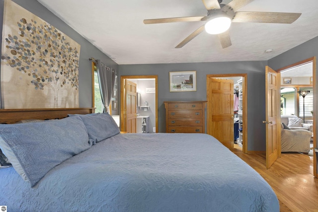 3048 Frankfort Hwy, Frankfort, MI 49635 - bedroom featuring light wood finished floors, multiple windows, a ceiling fan, and ensuite bathroom