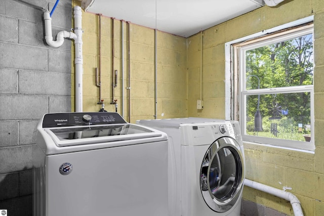 3048 Frankfort Hwy, Frankfort, MI 49635 - laundry area with concrete block wall and washing machine and dryer