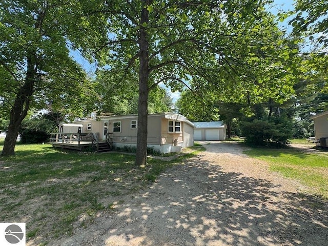 126 Chippewa Trl, Buckley, MI 49620 - view of front of house with an outbuilding, a deck, and a garage