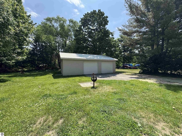 126 Chippewa Trl, Buckley, MI 49620 - view of grassy yard featuring a garage and an outbuilding