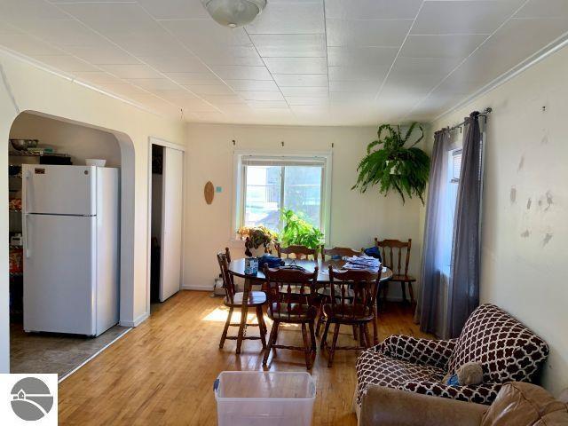 180 S Benzie Blvd, Beulah, MI 49617 - dining room featuring arched walkways and wood finished floors