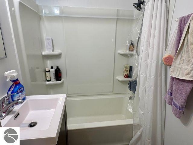 180 S Benzie Blvd, Beulah, MI 49617 - bathroom with shower / bath combination with curtain and vanity