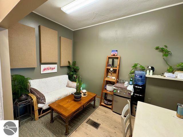 180 S Benzie Blvd, Beulah, MI 49617 - living area featuring light wood finished floors and ornamental molding