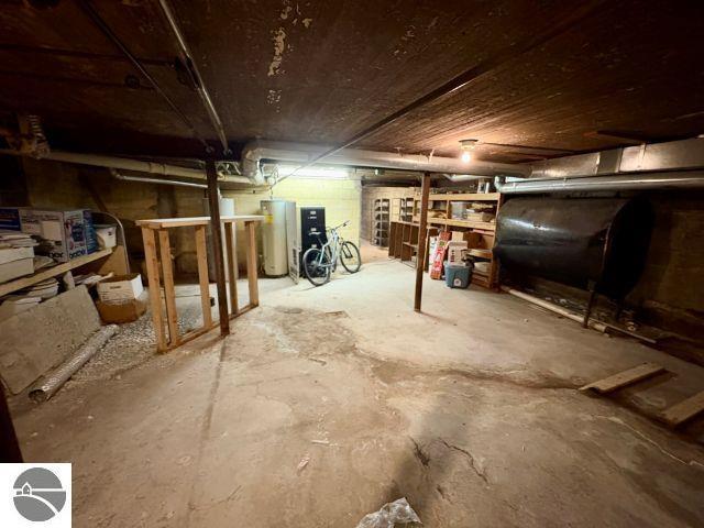 180 S Benzie Blvd, Beulah, MI 49617 - unfinished below grade area featuring heating fuel and water heater