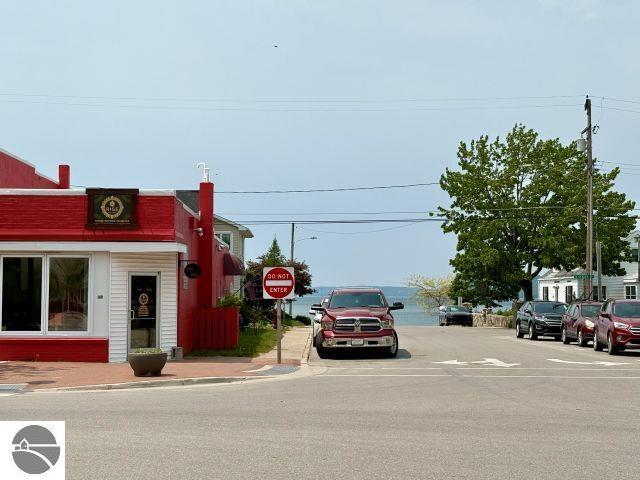 180 S Benzie Blvd, Beulah, MI 49617 - view of asphalt street featuring curbs, sidewalks, traffic signs, and street lighting